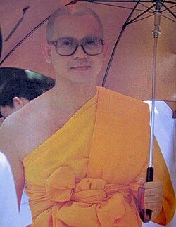 Luang Por Dhammajayo as a young monk with umbrella