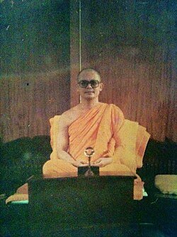 Young abbot Luang Por Dhammajayo seated in meditation