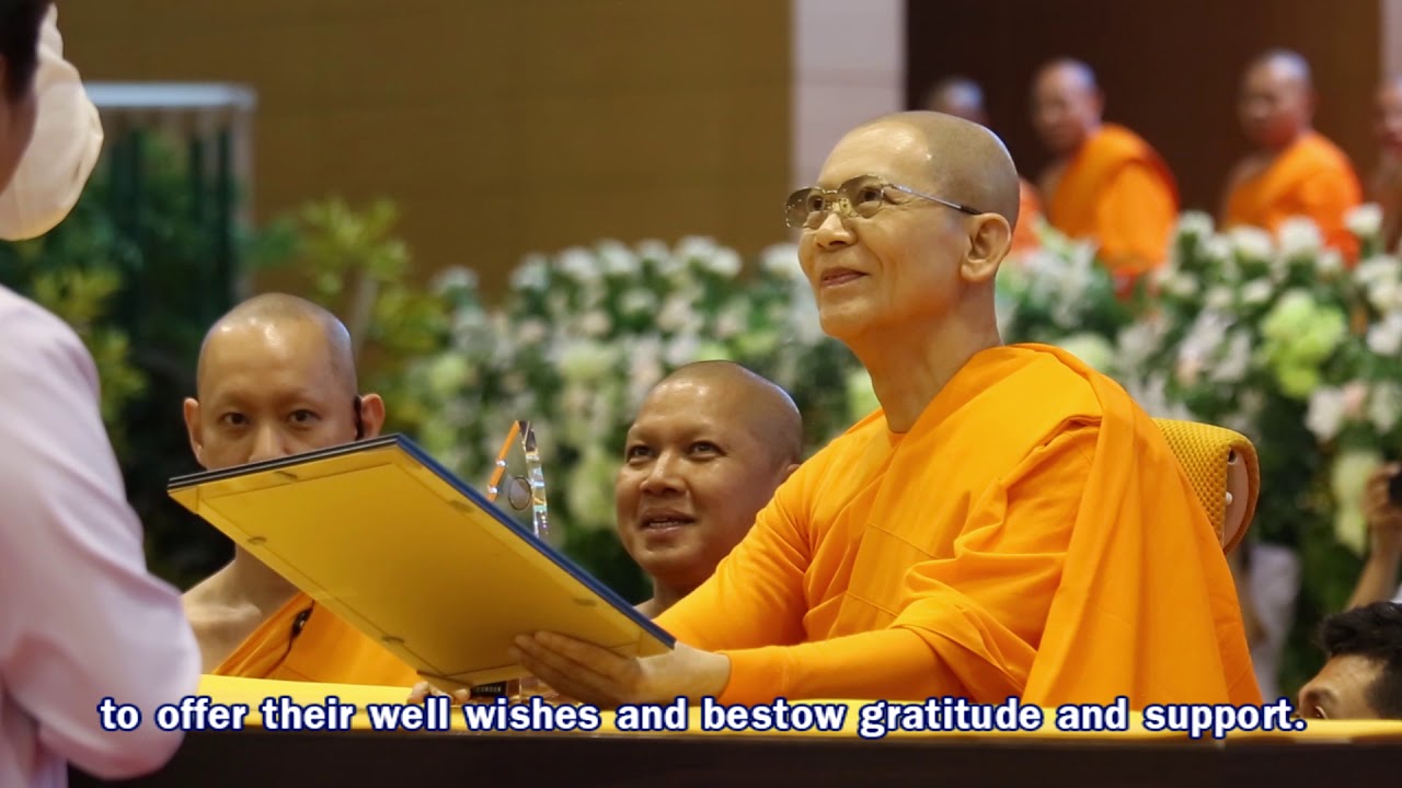 Luang Por Dhammajayo receiving an honorary award at a ceremony